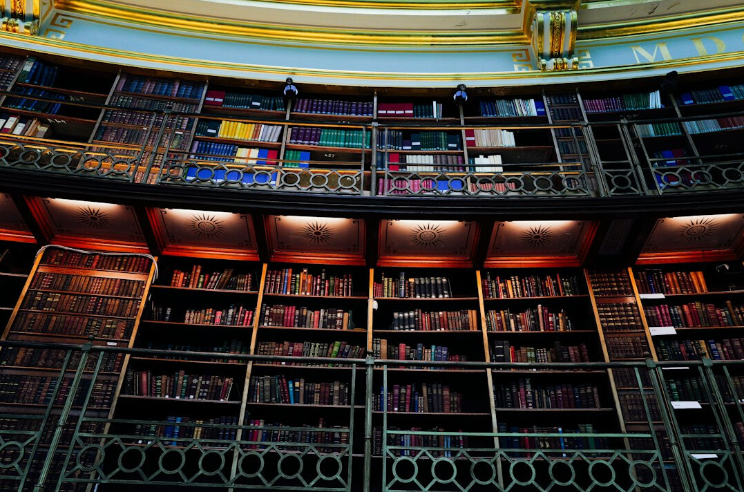 Interior of a grand library with tall bookshelves